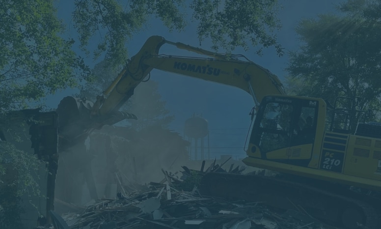 Photo of a Komatsu excavator demolishing a building